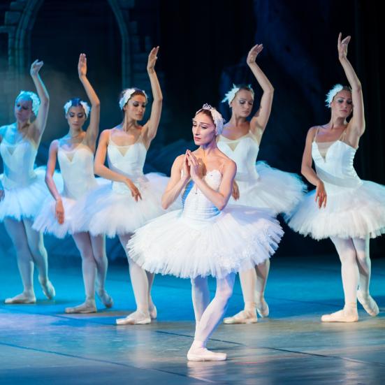Gruppe af kvindelige balletdansere på scenen.