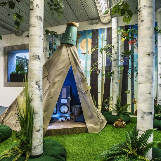 Installation af birkestammer og hule - inspireret af billedbogen Garmanns Hemmelighed.