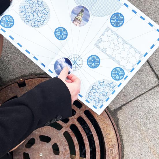 sætte klistermærke på kort ved lydbrønd